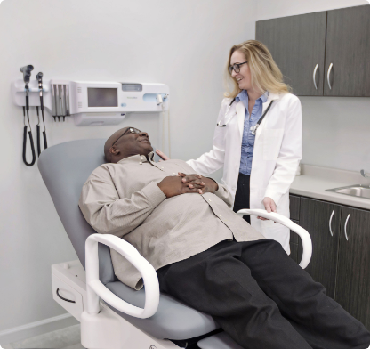 Front view of 4070 Manual Back Exam Table with seamless upholstered top and foot control