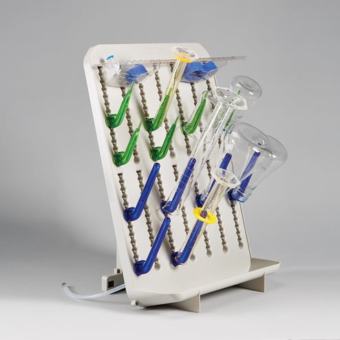 Adjustable laboratory drying rack with blue and green pegs and drying baskets