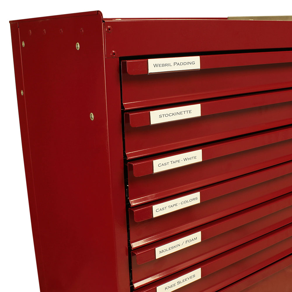 Clear plastic label holders attached to Harloff cast cart drawers for supply organization