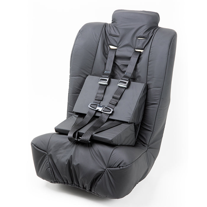 Angled view of the Spirit Spica car seat highlighting its low-profile design, padded upholstery, and safety harness.
