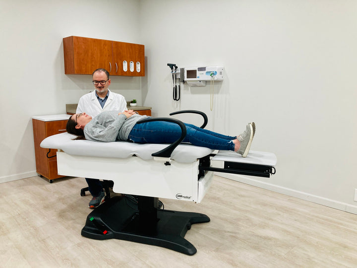 Medical examination table with seamless upholstery and optional drawer warmer – clinical setting