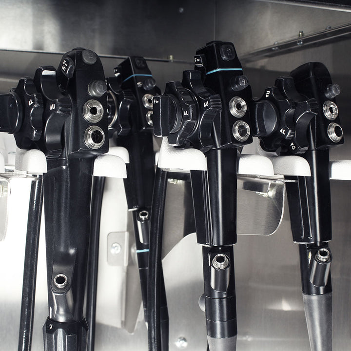 Close-up of stainless endoscope mounting system inside cabinet