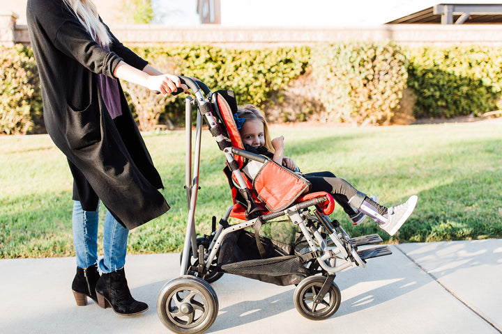 Trotter pediatric chair side view with transit-ready frame